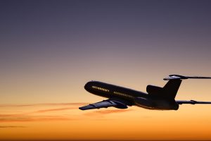 Afterglow. Passenger airplane silhouette on the evening-glow background.